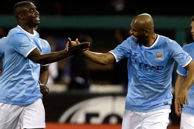 Manchester City's Micah Richards, left, is congratulated teammate Sisenando Maicon after scoring the game-winning goal during the second half of an exhibition soccer match against Chelsea, Thursday, May 23, 2013, at Busch Stadium in St. Louis. Manchester City won 4-3. (AP Photo/Jeff Roberson) 