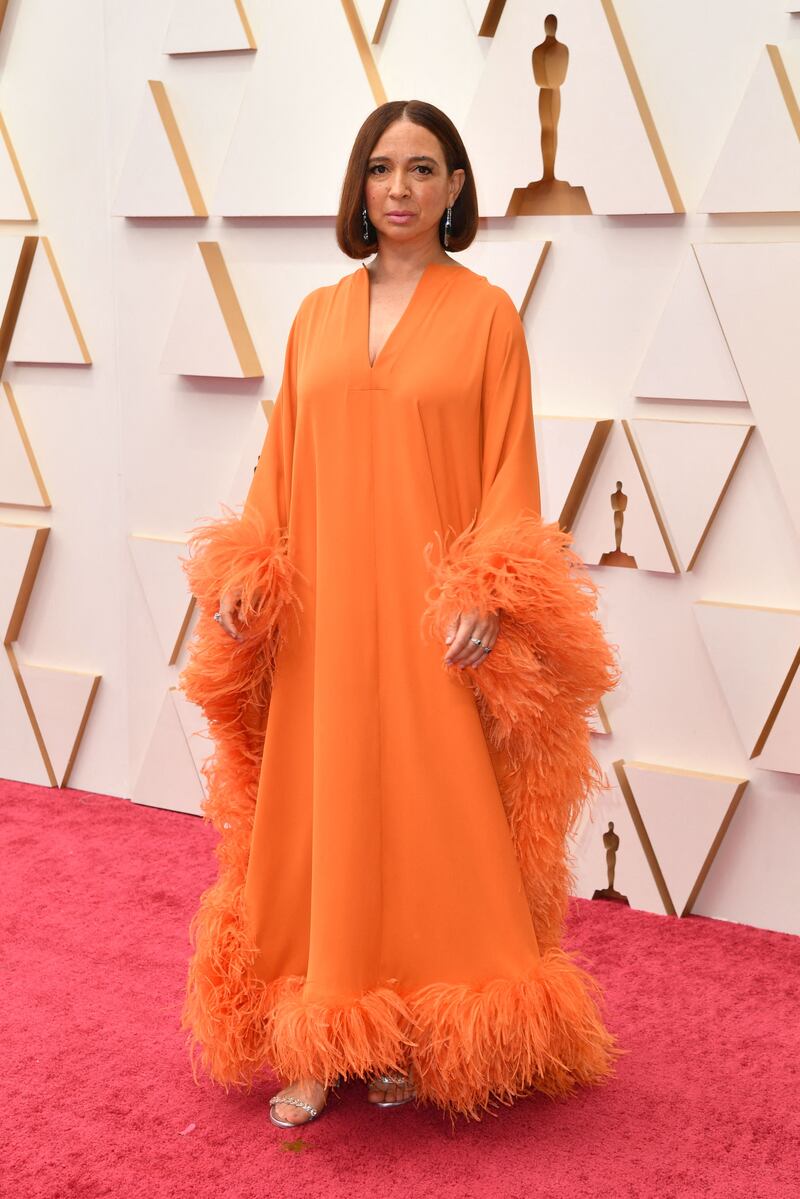 Maya Rudolph, wearing a feathered orange dress. AFP