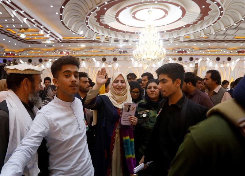 Parliamentary election candidate Suhaila Sahar waves among supporters during an election campaign in Kabul. Reuters