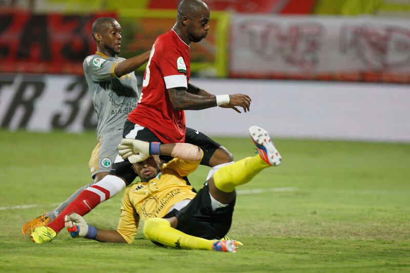 Dubai, United Arab Emirates, Oct 21, 2012, Al Ahli v  Al Shabab, Al Rashid Stadium . Al Ahli's 23 Grafite shoots on goal as Al Shabab GK is run over by Grafite during action at Al Rashid Stadium  Oct 21 2012. Mike Young / The National 