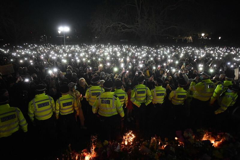 People gathered at Clapham Common, London, UK, to pay their respects to kidnap and murder victim Sarah Everard, turn on their phone torches in tribute. They gathered on Saturday night despite a vigil being cancelled, after police outlawed it due to Covid-19 restrictions. AFP