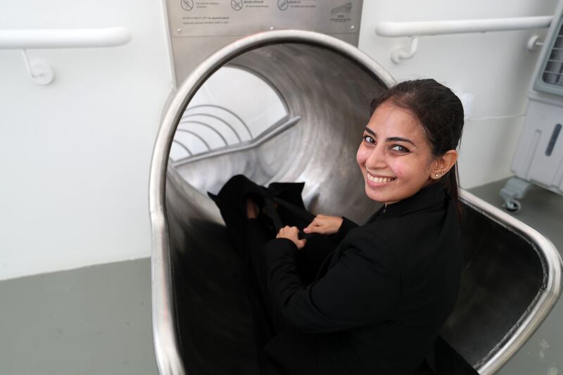 Shireen Shakeel rides the slide inside the Luxembourg pavilion. Photo: Chris Whiteoak / The National