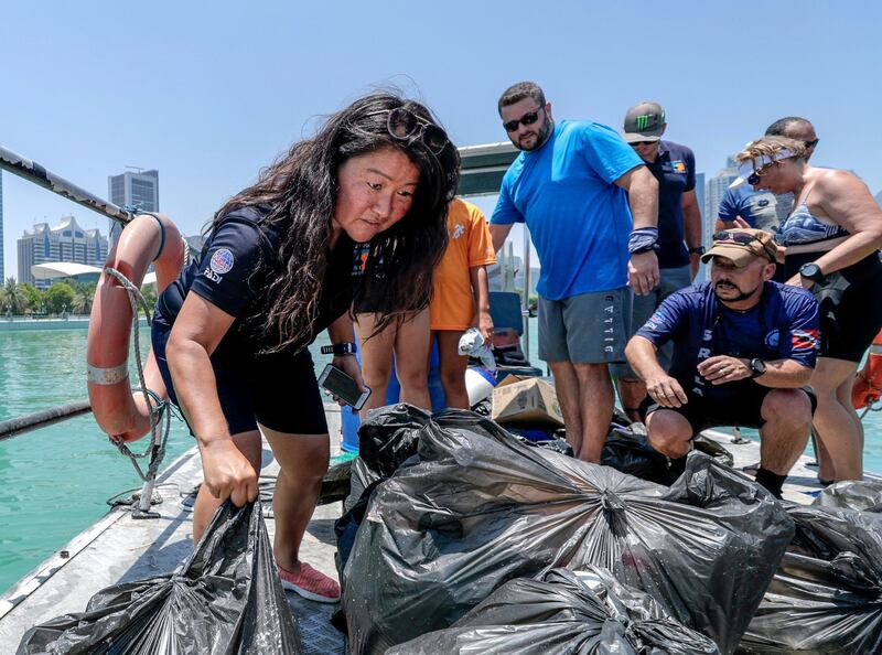 Abu Dhabi, United Arab Emirates, June 15, 2019.  
AUH clean up mission by volunteers at the Abu Dhabi Dhow Harbour. --  Dive volunteers sort out  the collected bags of trash.
Victor Besa/The National
Section:  NA
Reporter:  Anna Zacharias