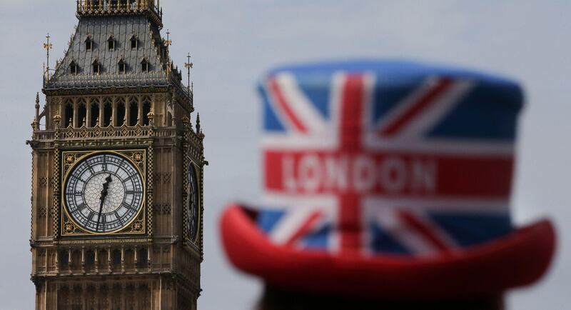 A tour guide, wearing a Union Flag and London-themed hat, stands near one of the four faces of the Great Clock of the Elizabeth Tower, commonly referred to as Big Ben, at the Houses of Parliament in central London on August 14, 2017.
Britain's much-loved Big Ben will fall silent for four years from August 21, as conservation work is carried out on the famous 19th century bell in a clock tower next to the Houses of Parliament. The Great Bell, popularly called Big Ben, weighs 13.7 tonnes and strikes every hour to the note of E. Four smaller bells also chime every 15 minutes. The last bong before the refurbishment will be at 12 pm (1100 GMT) on August 21, the statement said. / AFP PHOTO / Daniel LEAL-OLIVAS