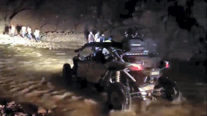 Police use a quad bike to reach the 20 people who were led to higher ground by the bus driver. Courtesy: Dubai Police