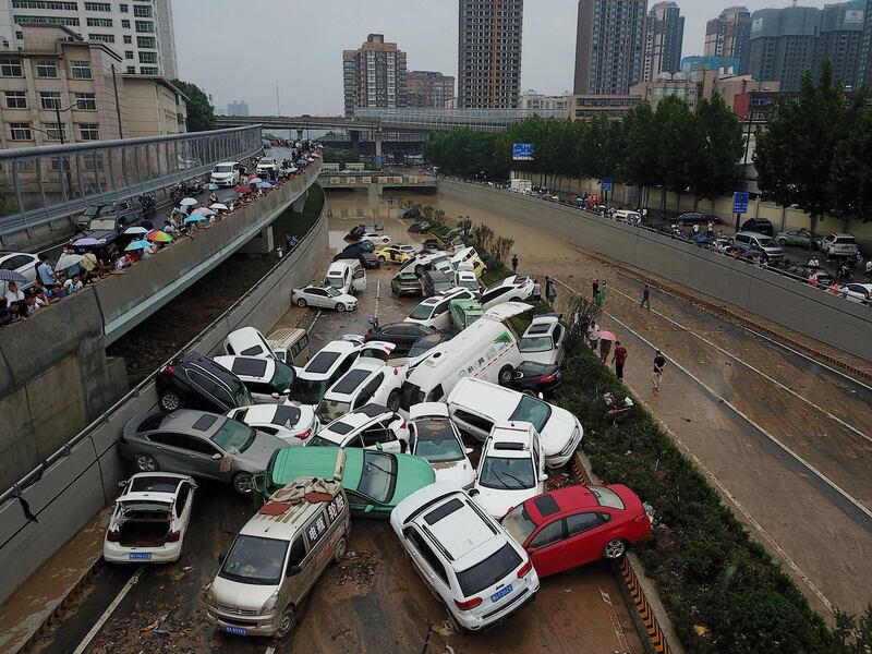 An aerial view shows cars sitting in floodwaters at the entrance of a tunnel after heavy rains hit the city of Zhengzhou in China's central Henan province.