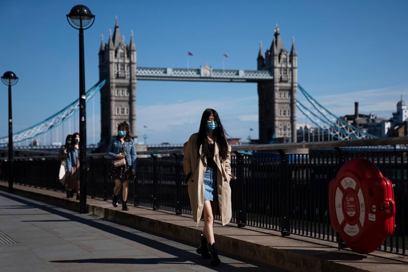 epa08403142 Members of the public pass Tower Bridge, Central London, Britain, 05 May, 2020. Britons are now in their sixth week of lockdown due to the spread of the SARS-CoV-2 coronavirus which causes the Covid-19 disease.  EPA/WILL OLIVER