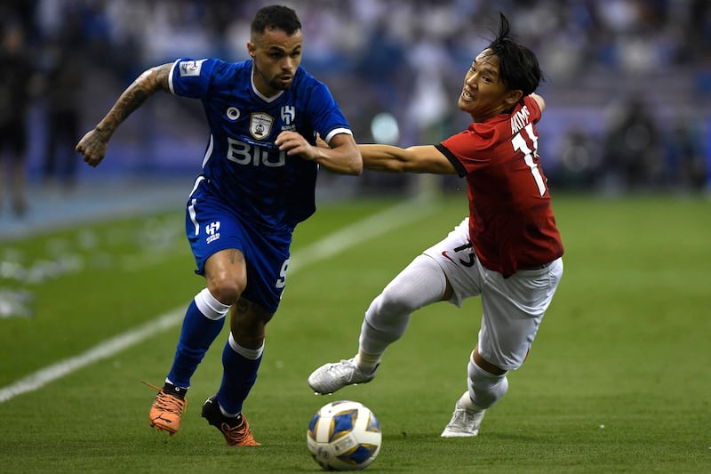 Hilal forward Michael is marked by Urawa defender Takahiro Akimoto. AFP