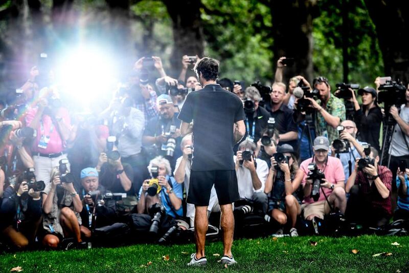 Switzerland’s Roger Federer poses with his Australian Open Men’s Singles trophy during a photo shoot at Carlton Gardens in Melbourne, Australia. Filip Singer / EPA