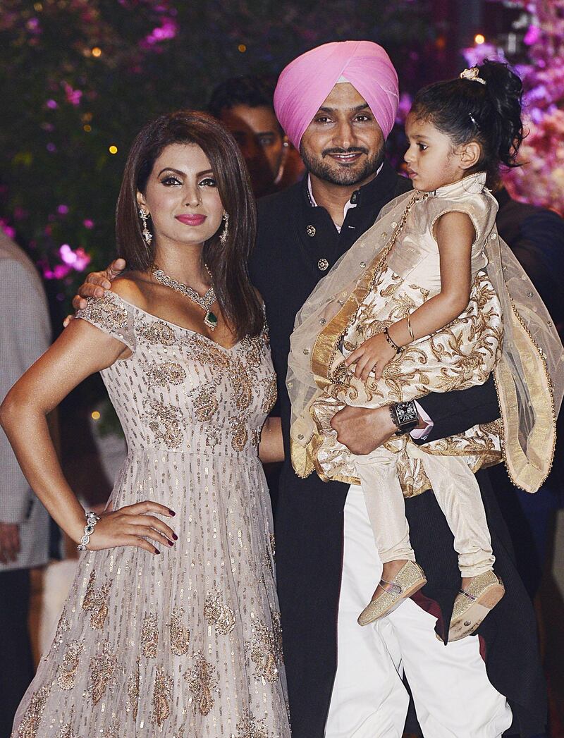 Indian Cricketer Harbhajan Singh poses for a picture with his wife and actress Geeta Basra along with their daughter Hinaya as they attend the engagement party of India's richest man and Reliance Industries Limited Chairman, Mukesh Ambani’s eldest son Akash Ambani and fiancee Shloka Mehta, in Mumbai late on June 30, 2018. AFP