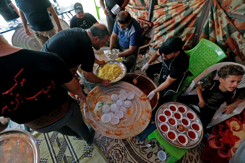Iraqi volunteers prepare food for Shiite Muslim pilgrims as they walk to Kerbala, ahead of the Shiite ritual of Arbaeen. Reuters