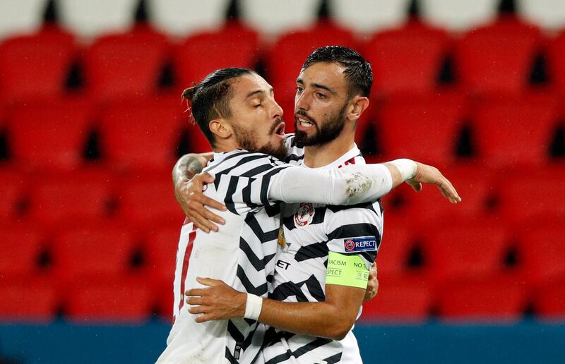 Bruno Fernandes (R) celebrates with teammate Alex Telles after scoring the first goal from a penalty. EPA