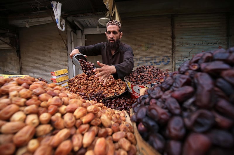 A man  in Peshawar, Pakistan, sells date palms, a popular appetiser for breaking the fast during Ramadan. EPA