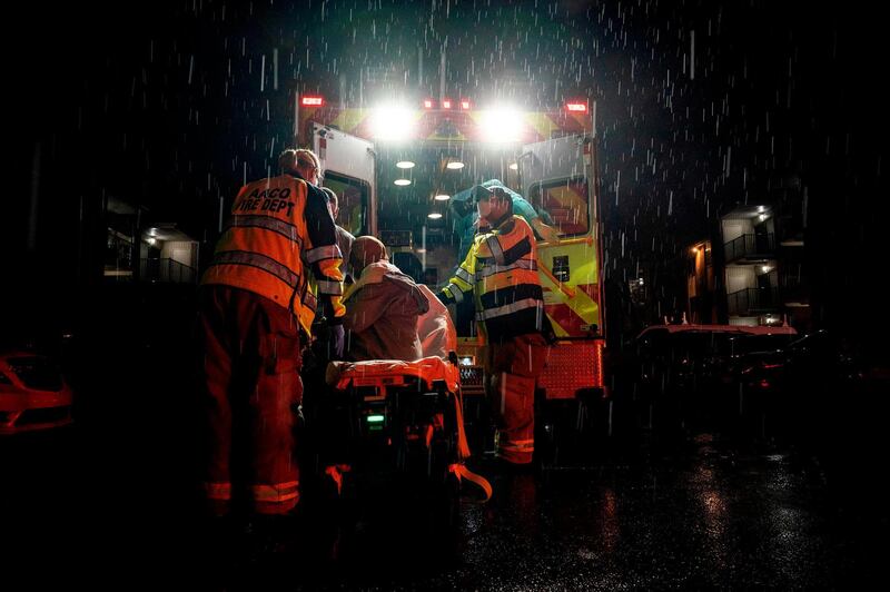 Firefighters and paramedics with Anne Arundel County Fire Department wear enhanced PPE while preparing to transport a suspected coronavirus patient in Glen Burnie, Maryland.  As of this morning Maryland has 24,473 confirmed Covid-19 cases out of 1.18 million confirmed US cases. AFP