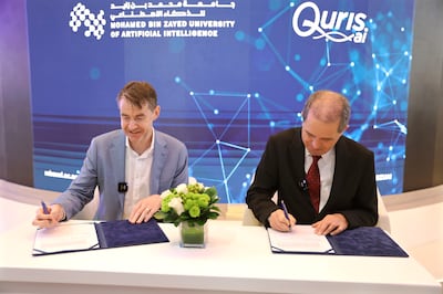 MBZUAI Provost Timothy Baldwin and Founder and CEO of Quris-AI, Isaac Bentwich M.D. signing the partnership agreement at ADSW.
