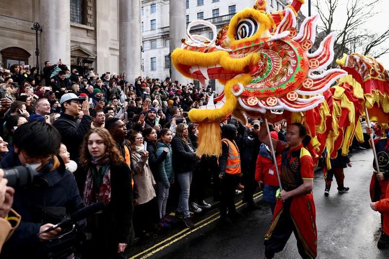 People take part in a parade during celebrations for the Lunar Chinese New Year of the Dragon in London. Reuters