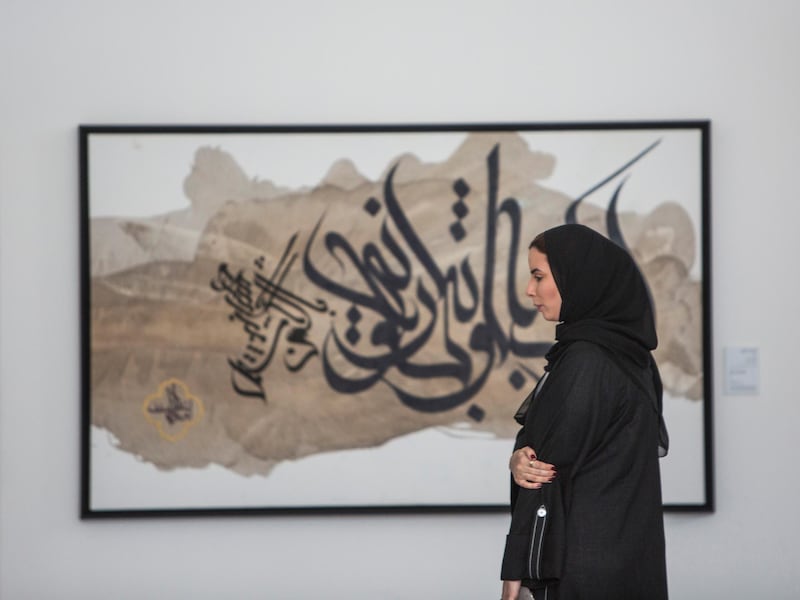 ABU DHABI, UNITED ARAB EMIRATES -An attendee looking at an artwork at the Al Burda Festival, Shaping the Future of Islamic Art and Culture at Warehouse 421, Abu Dhabi.  Leslie Pableo for The National for Melissa Gronlund’s story