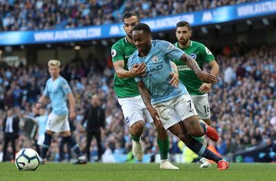 Manchester City's Raheem Sterling (7), right, battles with Brighton & Hove Albion's Martin Montoya during their English Premier League soccer match at the Etihad Stadium in Manchester, England, Saturday Sept. 29, 2018. (Martin Rickett/PA via AP)