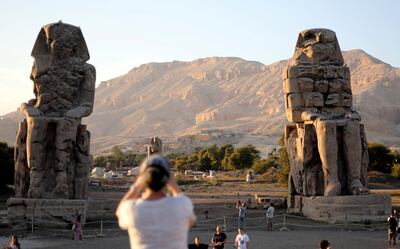 Tourists visit the Colossi of Memnon, the ruins of two stone statues that guarded the mortuary temple built for Pharaoh Amenhotep III, in Luxor, Egypt November 25, 2018. REUTERS/Mohamed Abd El Ghany