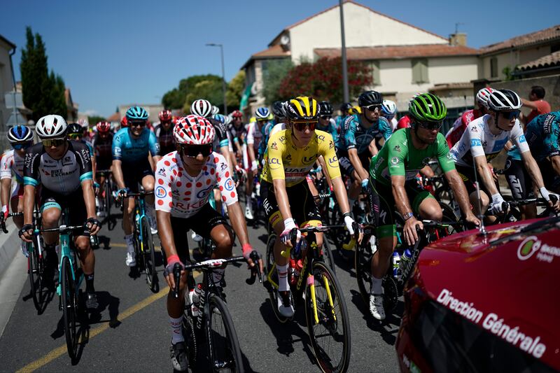 Tadej Pogacar, in yellow, Nairo Quintana, in the best climber's dotted jersey and Mark Cavendish, in the best sprinter's green jersey before the start of Stage 11.