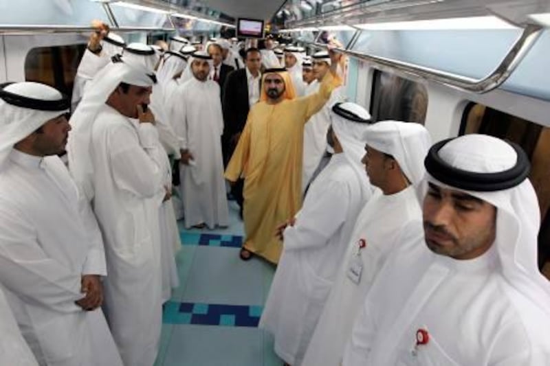 HH Sheikh Mohammed bin Rashid Al Maktoum Vice-President Prime Minister of the UAE and Ruler of Dubai (yellow) takes a ride through the second metro rail network during its inauguration, after a two-year delay, in the Gulf emirate of Dubai on September 9, 2011. AFP PHOTO/KARIM SAHIB

 *** Local Caption ***  790036-01-08.jpg