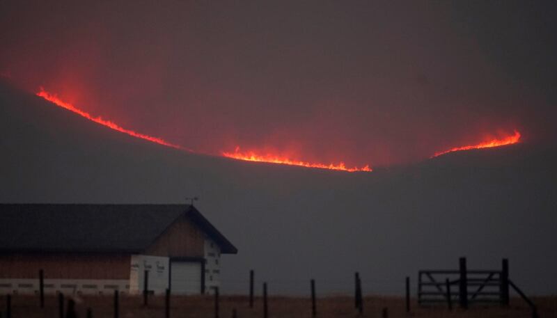 Flames rise from mountain ridges as a wildfire burns near Granby, Colorado, USA. AP Photo
