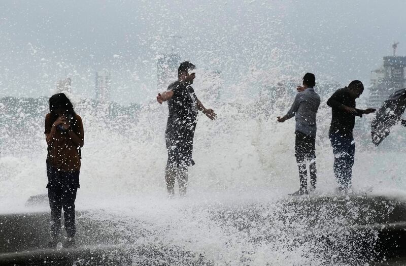 People enjoying the waves on the coast in Mumbai.  AP Photo 