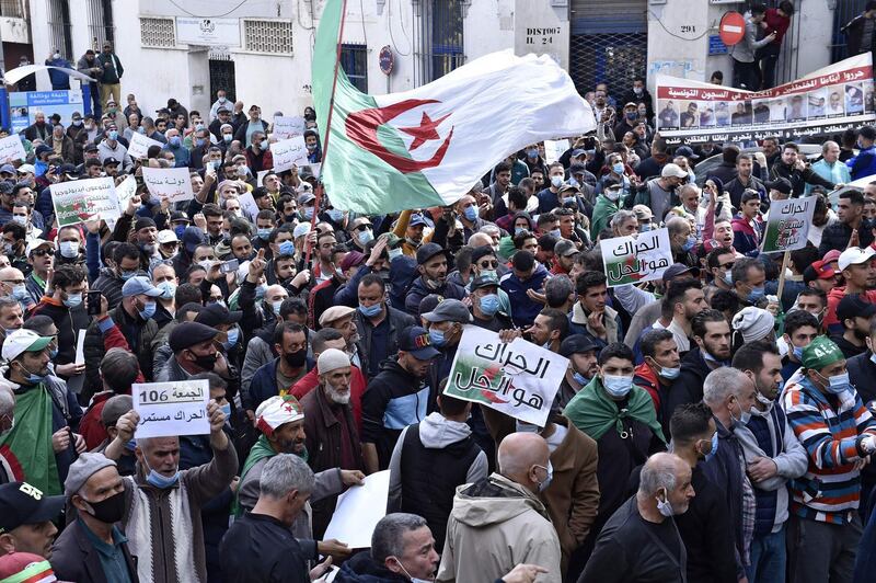 Algerian anti-government protesters take part in a demonstration in the capital Algiers, on February 26, 2021.  Thousands of anti-government protesters took to the streets across Algeria on Friday, as the "Hirak" pro-democracy movement gathers renewed momentum after a year-long hiatus due to the coronavirus pandemic. Despite a ban on gatherings over Covid-19, crowds rallied in several neighbourhoods of the capital Algiers in the early afternoon after Friday prayers and marched toward the city centre. / AFP / -
