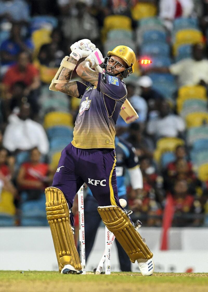 BRIDGETOWN, BARBADOS - SEPTEMBER 26: In this handout image provided by CPL T20, Sunil Narine of Trinbago Knight Riders is bowled by Jason Holder of Barbados Tridents (not in frame) during match 23 of the Hero Caribbean Premier League between Barbados Tridents and Trinbago Knight Riders at Kensington Oval on September 26, 2019 in Bridgetown, Barbados. (Photo by Randy Brooks - CPL T20/CPL T20 via Getty Images)