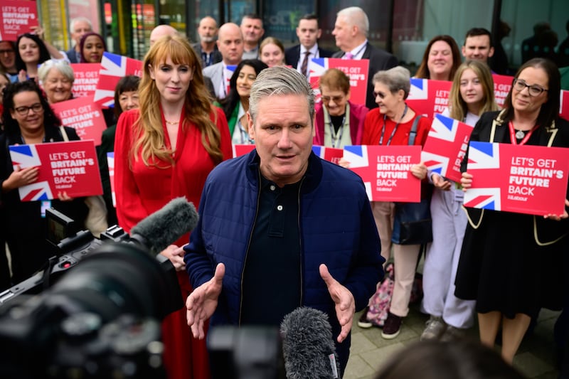 Mr Starmer's navy wardrobe does not stop at suits; he is seen here wearing a navy bomber jacket while campaigning in Liverpool in October 2023