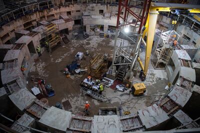 Employees work inside the ITER (International Thermonuclear Experimental Reactor) construction site where will be installed the Tokamak, a  confinement device being developed to produce controlled thermonuclear fusion power, in Saint-Paul-les-Durance, southern France on October 10, 2018. (Photo by CHRISTOPHE SIMON / AFP)