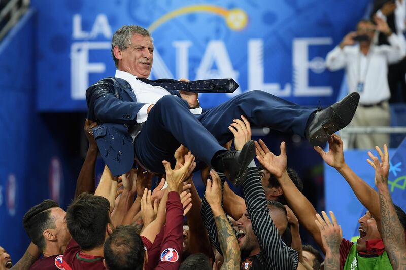 PARIS, FRANCE - JULY 10:  Fernando Santos manager of Portugal is thrown into the air by his players after his side win 1-0 against France during the UEFA EURO 2016 Final match between Portugal and France at Stade de France on July 10, 2016 in Paris, France.  (Photo by Matthias Hangst/Getty Images)