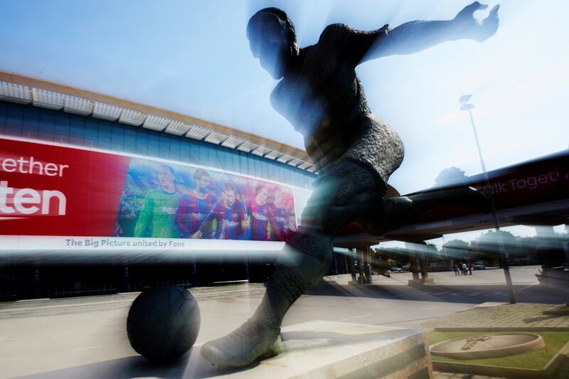 View of the facade of Camp Nou stadium picturing a collage of Barcelona players Lionel Messi, Gerard Pique, Frenkie De Jong, Marc-Andre Ter Stegen and Antoine Griezmann, made with photos shared by fans from worldwide. EPA