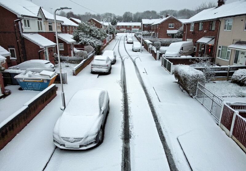 Snow covers a street in Liverpool after a heavy fall overnight. PA