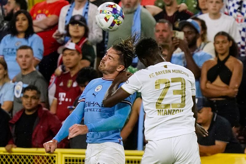 Jack Grealish, left, and Bayern Munich's Tanguy Nianzou go for the ball. AP