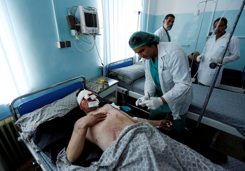 An injured man receives treatment after a suicide attack in Kabul, Afghanistan. Mohammad Ismail / Reuters