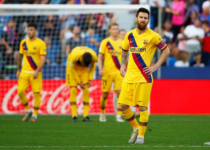 Barcelona's Lionel Messi looks dejected after Levante's Nemanja Radoja scored his team's third goal in Valencia. Reuters