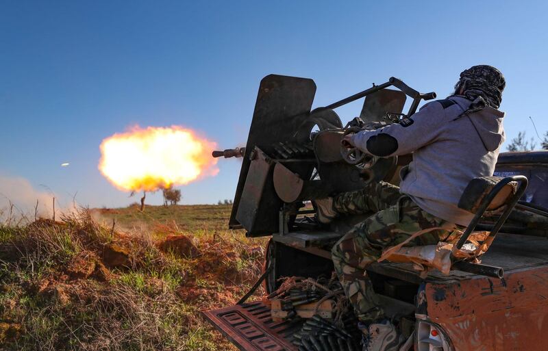 A Turkey-backed Syrian fighter fires a truck-mounted gun toward the town of Saraqeb from the outskirts of the villages of Afis and Salihiyah. AFP