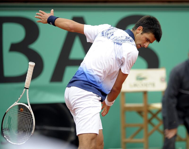 Novak Djokovic tosses his raCquet as he takes on Victor Hanescu during their third round match for the French Open in  2010. EPA