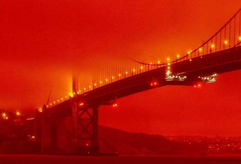 The Golden Gate Bridge is seen at 11 a.m. PT amid a smoky, orange hue caused by the ongoing wildfires, in San Francisco. AP