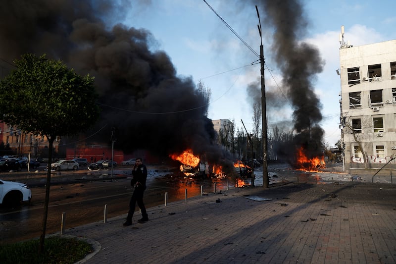 Cars burn after Russian missile strikes in Kyiv. Reuters