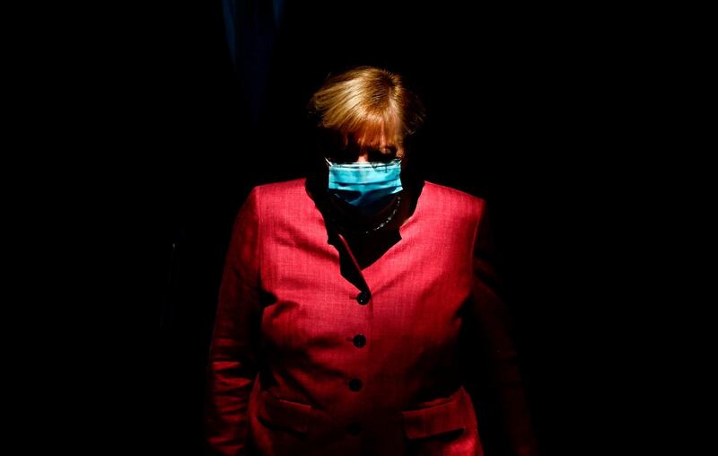 German Chancellor Angela Merkel wears a face mask as she arrives for a session of the German lower house of parliament Bundestag in Berlin. AFP