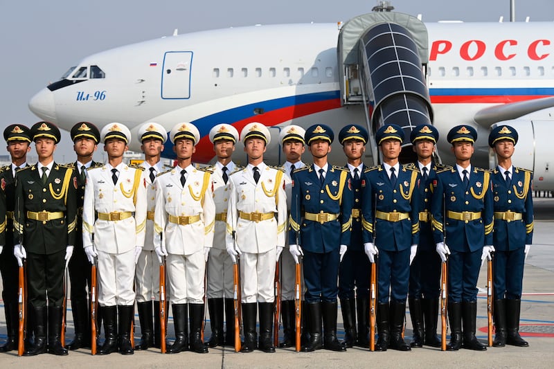 Chinese honour guards stand guard after welcoming Mr Putin at Beijing's international airport. Getty Images