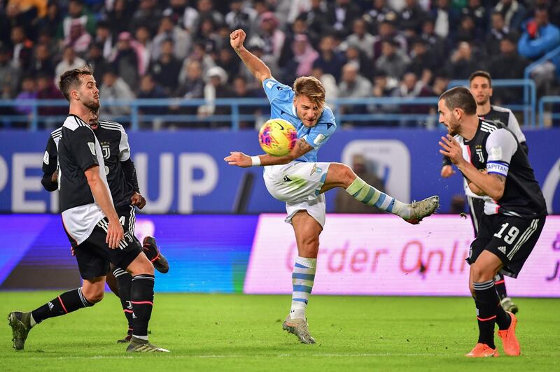 Lazio's Italian forward Ciro Immobile (C) attempts a shot. AFP