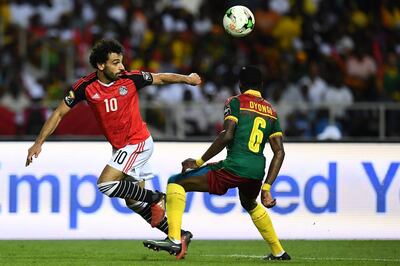 Egypt's forward Mohamed Salah (L) vies for the ball against Cameroon's defender Ambroise Oyongo during the 2017 Africa Cup of Nations final football match between Egypt and Cameroon at the Stade de l'Amitie Sino-Gabonaise in Libreville on February 5, 2017. / AFP PHOTO / GABRIEL BOUYS