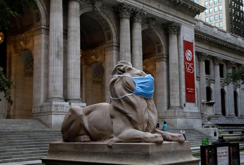 The lion statue in front of the 42nd Street New York Public Library adorns a protective mask. EPA