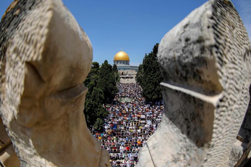 Palestinians perform Friday prayers outside the Dome of the Rock shrine at the Al Aqsa Mosque compound, Islam’s third-holiest site, in Jerusalem's Old City. AFP