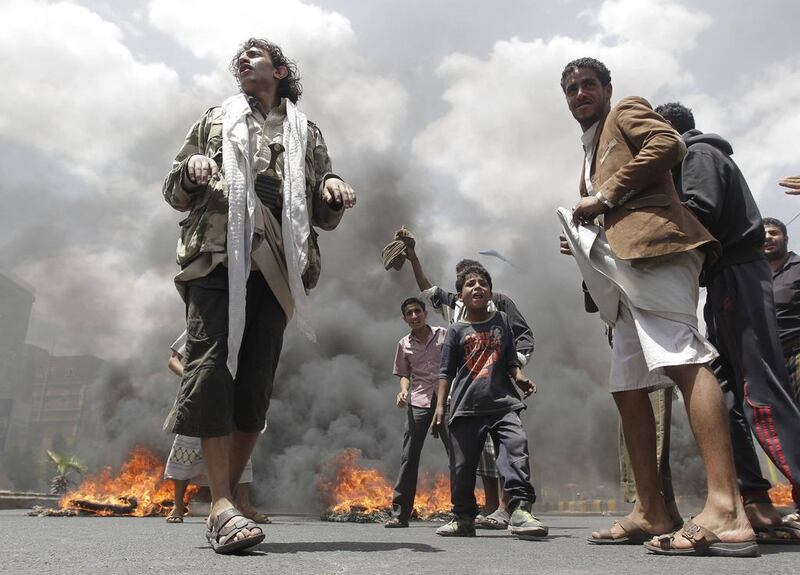 Protesters burn tyres during a demonstration against Yemen’s fuel shortages near the house of President Abdu Rabbu Mansour Hadi in Sanaa. Khaled Abdullah / Reuters