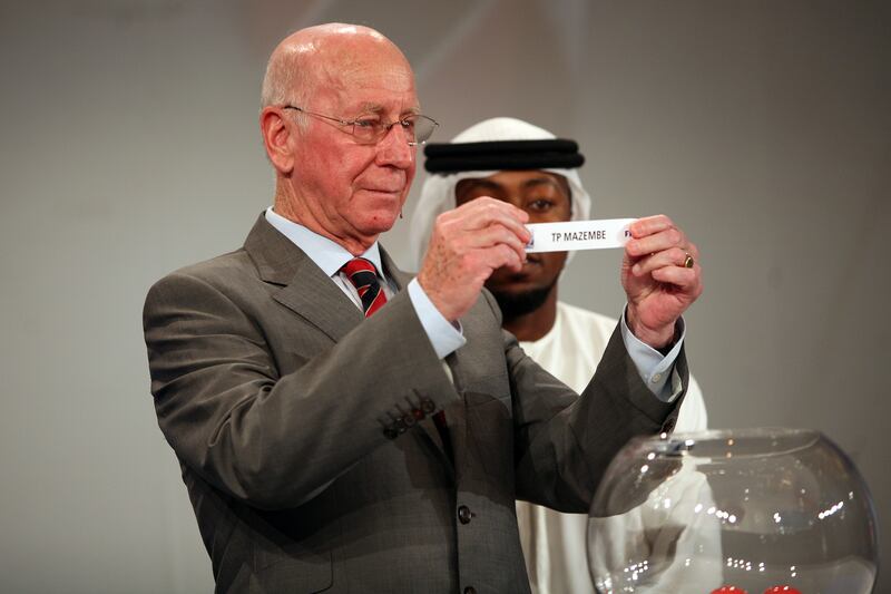 November 12, 2009 / Abu Dhabi / (Rich-Joseph Facun / The National) Bobby Charlton (CQ), former World Cup winner and European Footballer of the Year, left, draws the first team (Mazembe) as Ismail Matar Al-Junaibi (CQ), Al Wahda footballer, right, looks on at the start the official draw of the FIFA World Cup UAE 2009, Thursday, November 12, 2009 in Abu Dhabi.  *** Local Caption ***  rjf-1112-FIFAdraw006.jpg