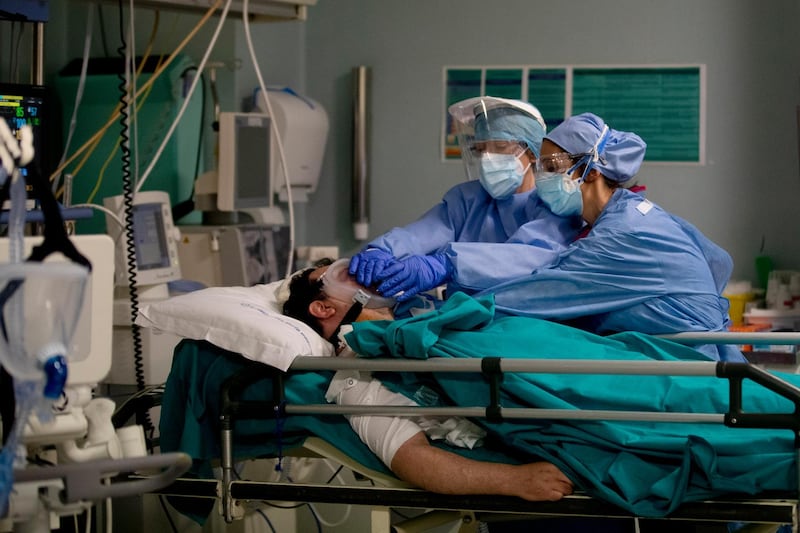 FILE - In this April 16, 2020 file photo, medical staff tend to a patient in the emergency COVID-19 ward at the San Carlo Hospital in Milan, Italy. As Italy prepares to emerge from the Westâ€™s first and most extensive coronavirus lockdown, it is increasingly clear that something went terribly wrong in Lombardy, the hardest-hit region in Europeâ€™s hardest-hit country. By contrast, Lombardyâ€™s front-line doctors and nurses are being hailed as heroes for risking their lives to treat the sick under extraordinary levels of stress, exhaustion, isolation and fear. (AP Photo/Antonio Calanni, file)